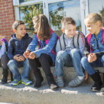 students outside school standing together